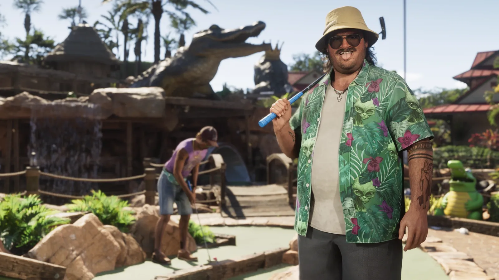 Cal at a mini golf course decorated with fake alligators.